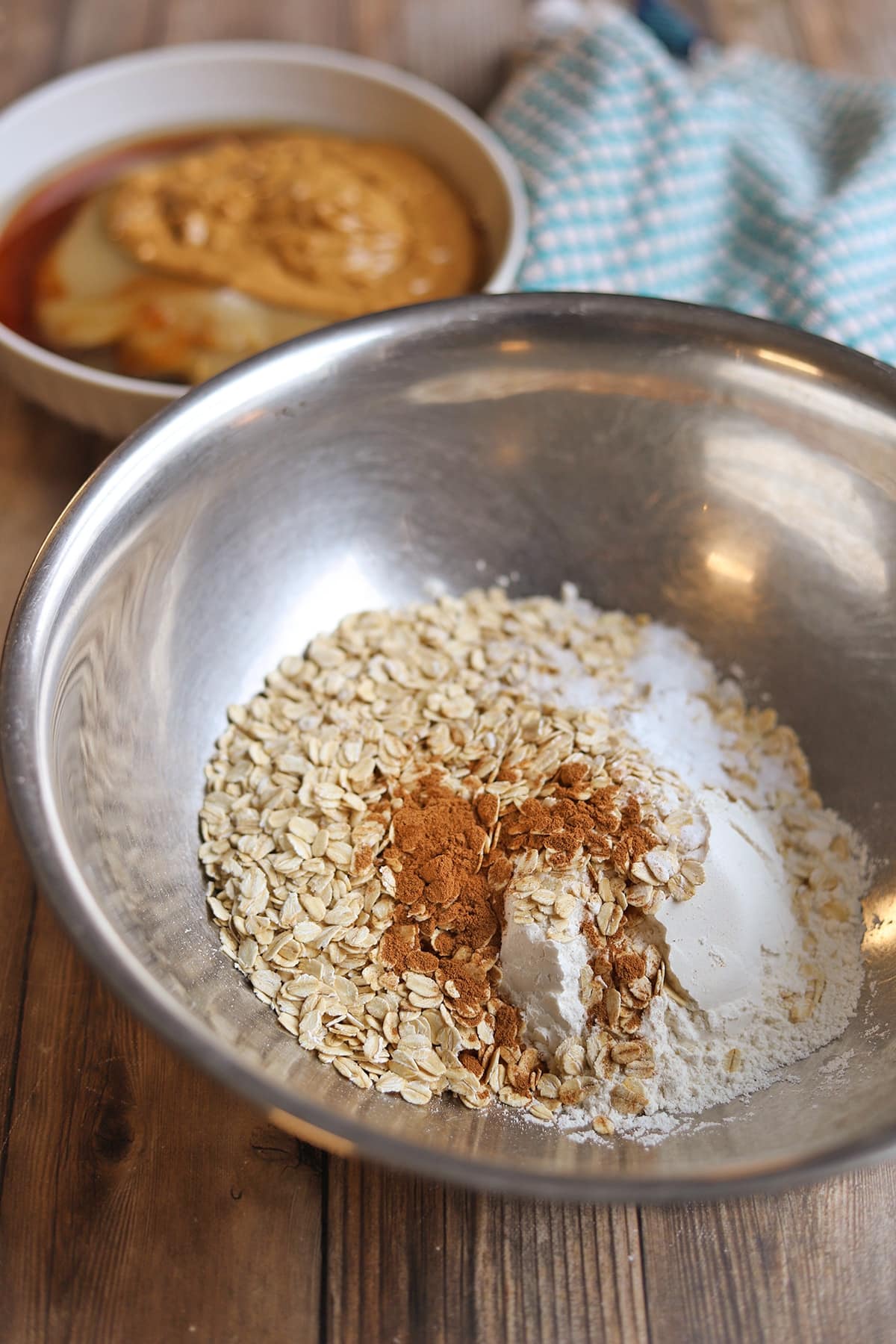 Dry ingredients for cookies in mixing bowl by wet ingredients.