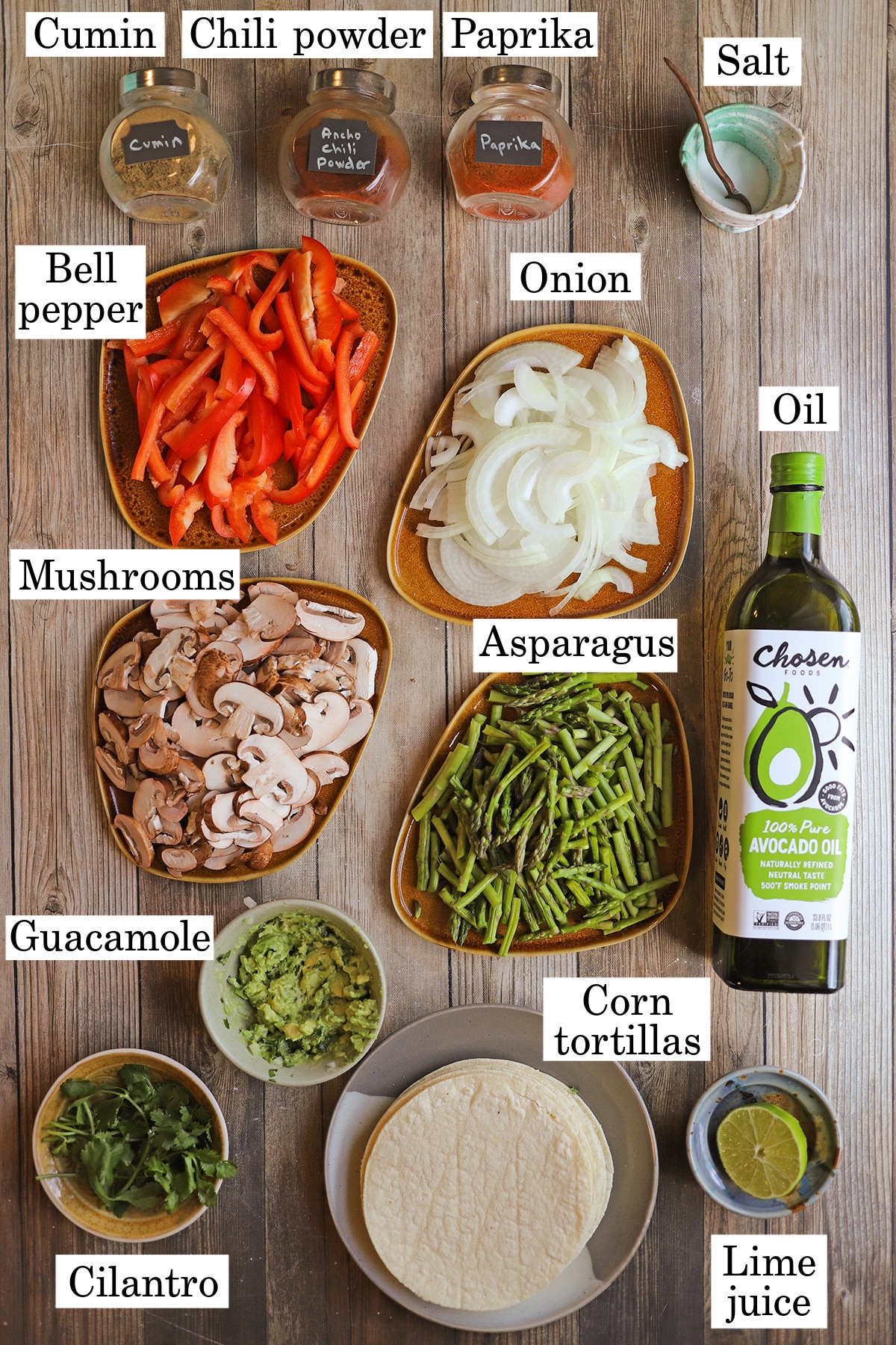 Labeled ingredients for grilled vegetable fajitas on table.