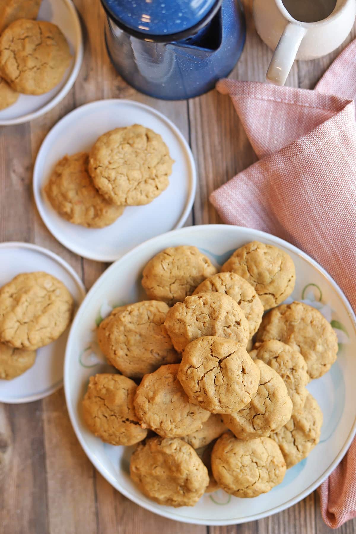 Platter of cookies with napkin and coffee pot.