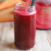Bright reddish pink ABC juice in glass.