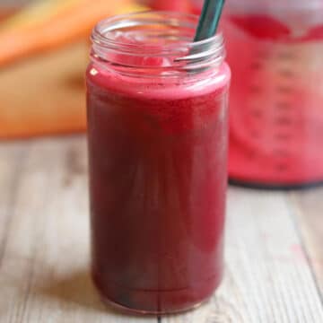 Bright reddish pink ABC juice in glass.