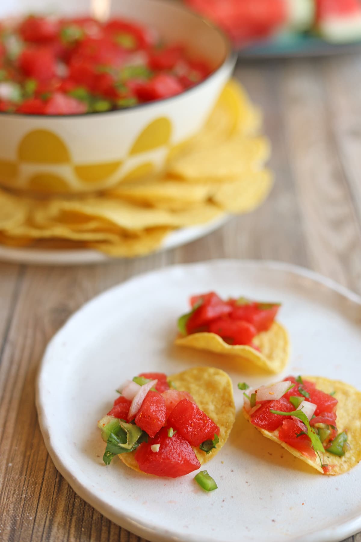 Tortilla chips topped with dollops of watermelon salsa.