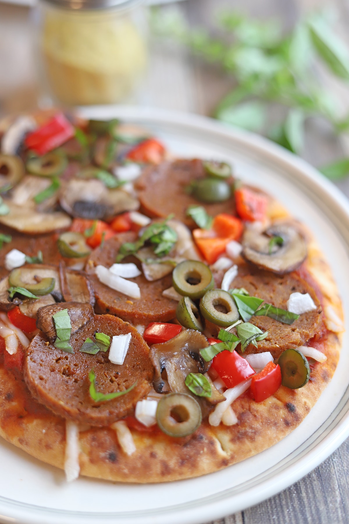 Vegan pepperoni, olives, muhsrooms, bell pepper, onion, and vegan cheese on naan flatbread pizza.