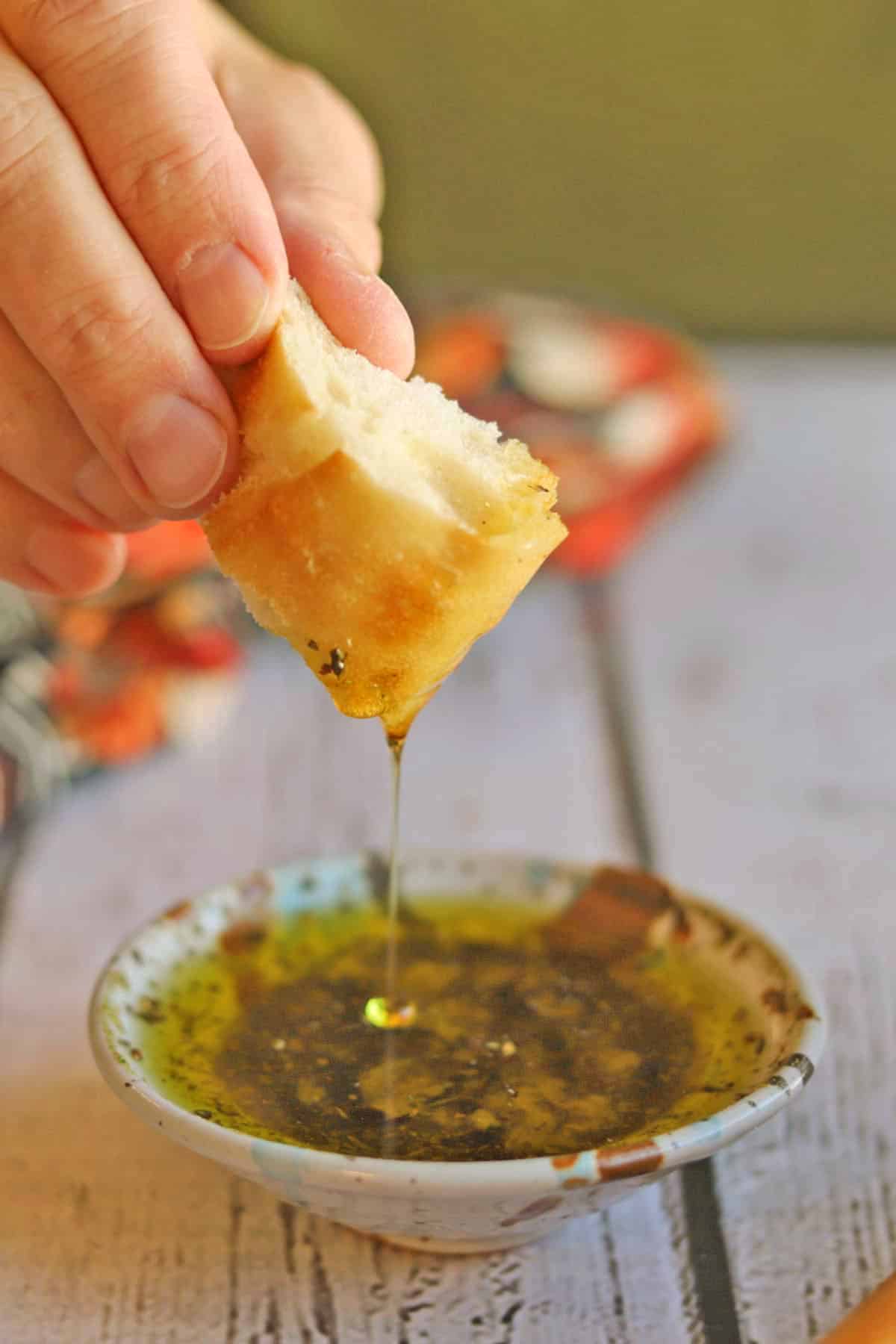 Seasoned oil dripping off of piece of bread.