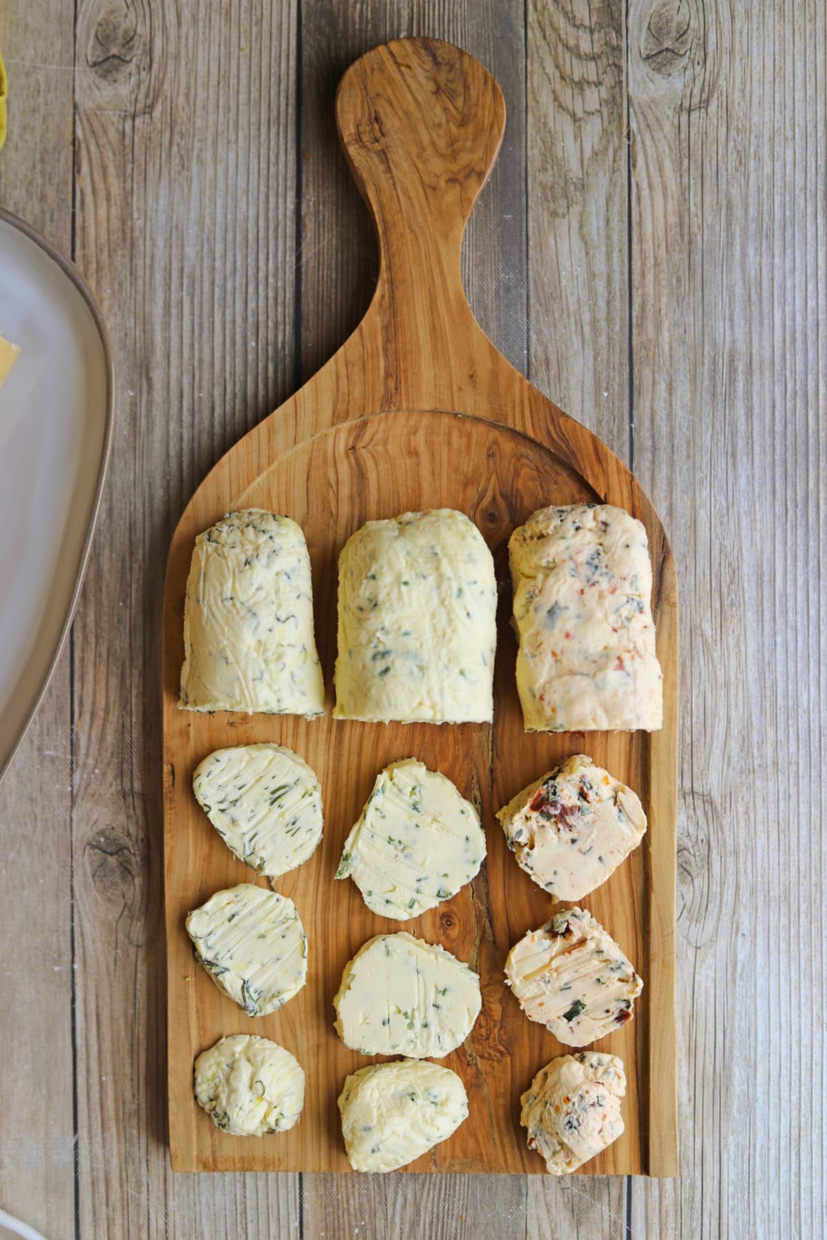 Vegan butter board with flavored non-dairy butter in slices.