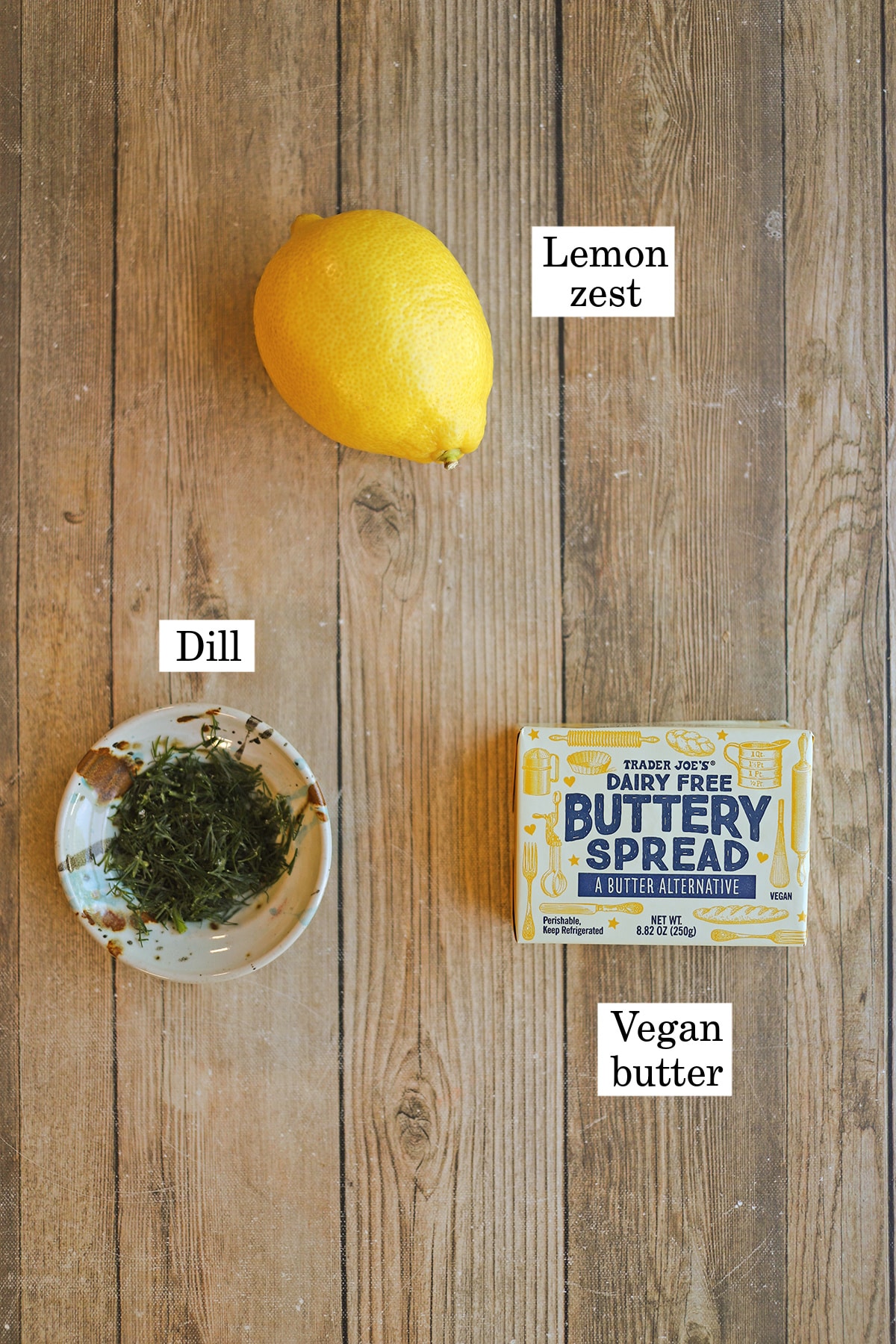 Labeled ingredients for vegan compound butter with dill, lemon zest, and buttery spread.