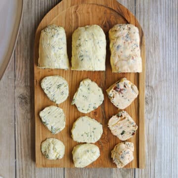 Vegan butter board with three flavors of non-dairy butter - chive & garlic, lemon & dill, and sun-dried tomato & basil.