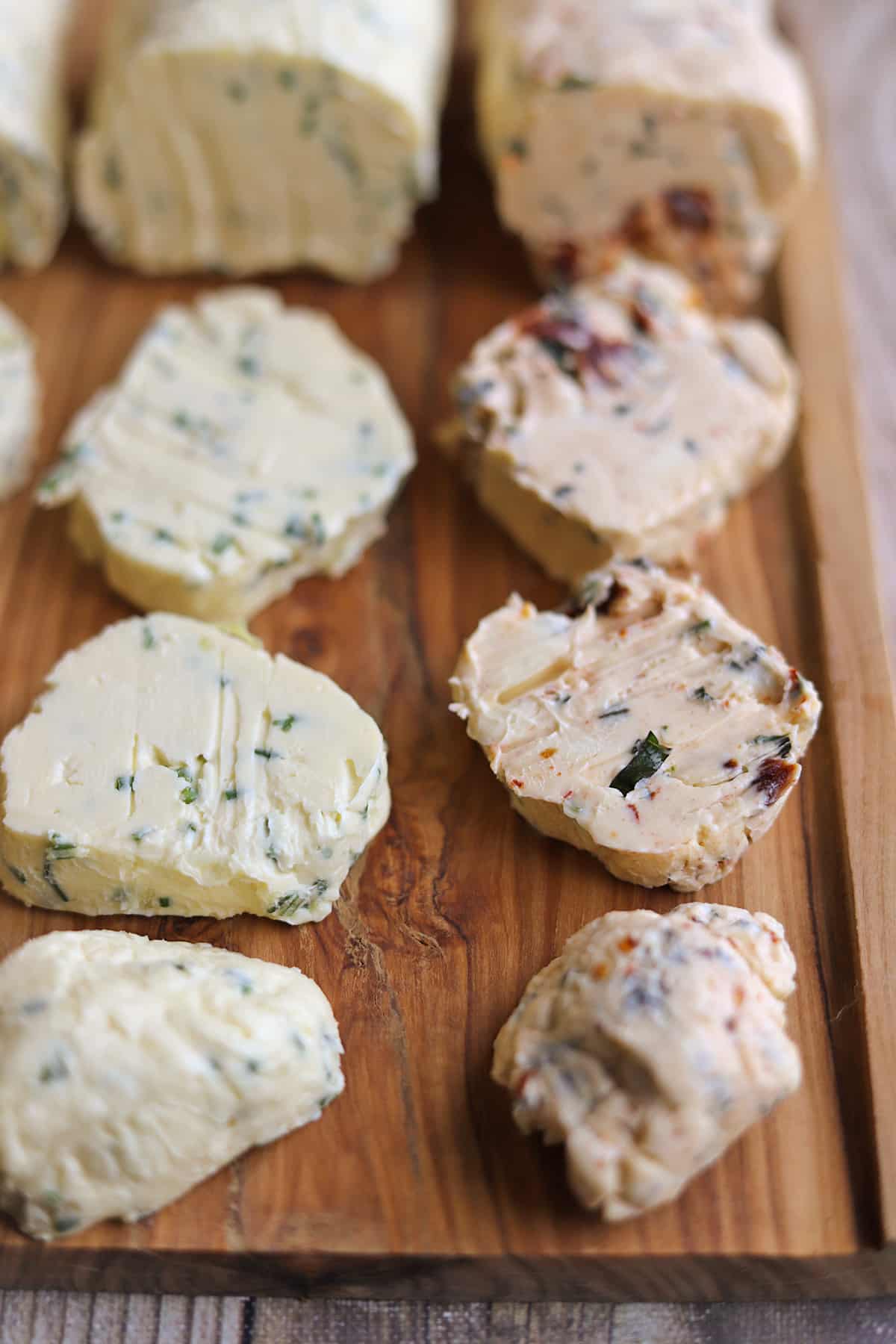 Slices of flavored non-dairy butter - sun dried tomato & basil with garlic, and chive & garlic.