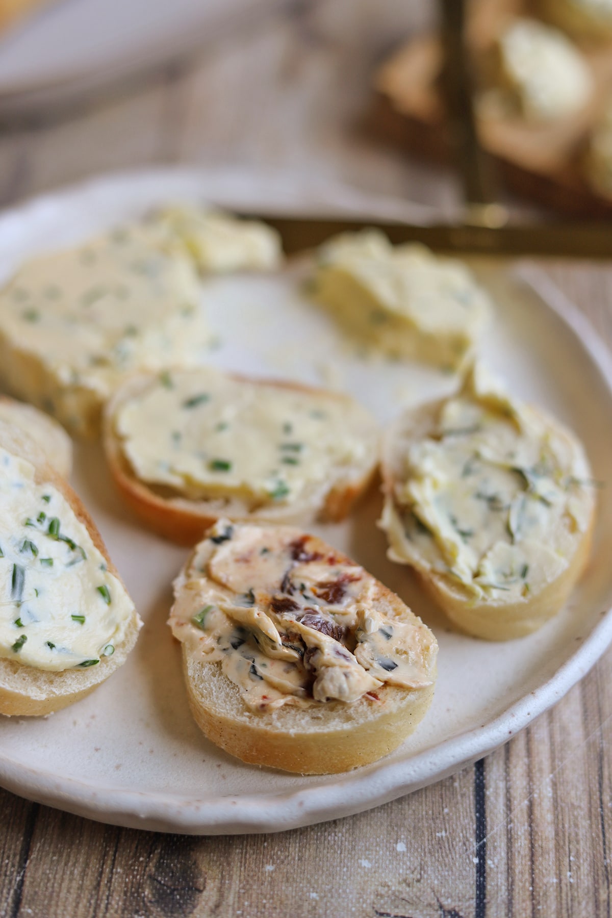 Bread slices smeared with tomato & basil spread, dill spread, and chive spread.