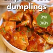 Text overlay: "Chipotle tofu dumplings. Spicy and crispy. Get the recipe at cadryskitchen.com." Platter of fried tofu dumplings in adobo sauce on plate.