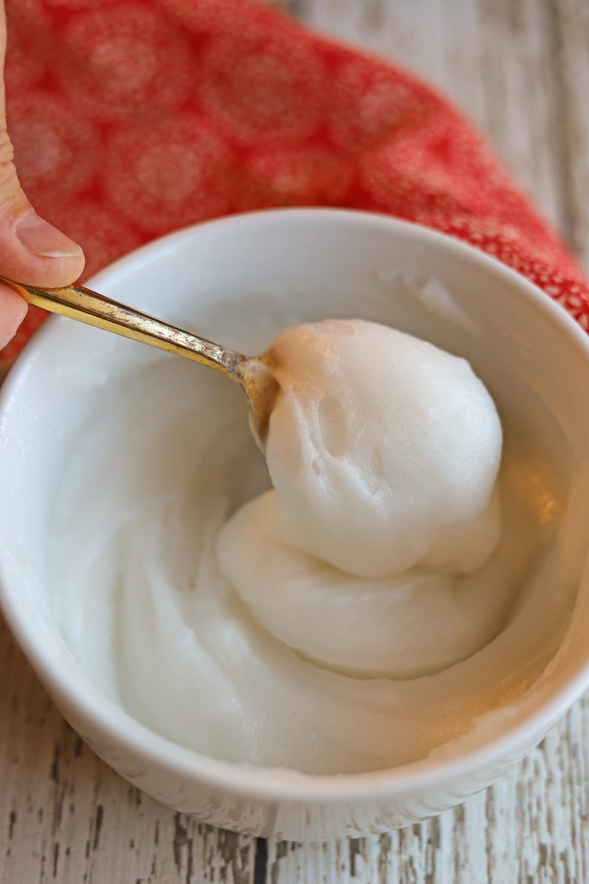 Coconut oil deodorant being stirred in bowl.