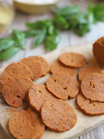 Sliced vegan pepperoni on cutting board.
