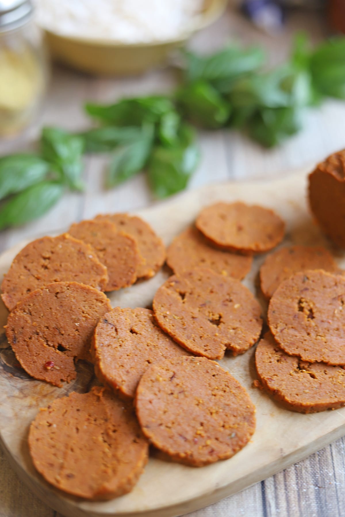 Sliced vegan pepperoni on cutting board.