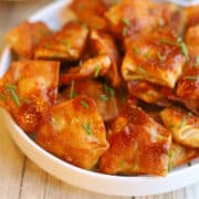 Saucy tofu dumplings in chipotle adobo sauce on plate.