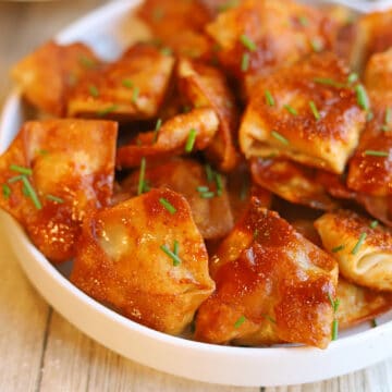 Saucy tofu dumplings in chipotle adobo sauce on plate.