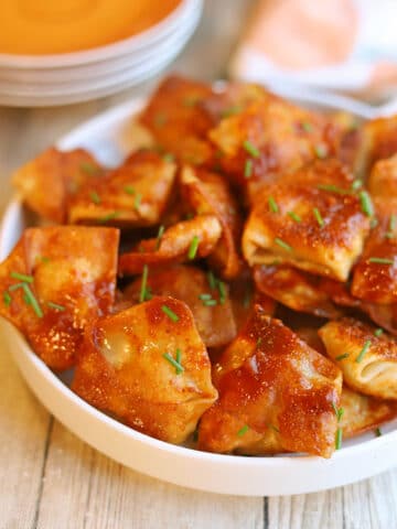 Vegan tofu dumplings with adobo sauce on platter.