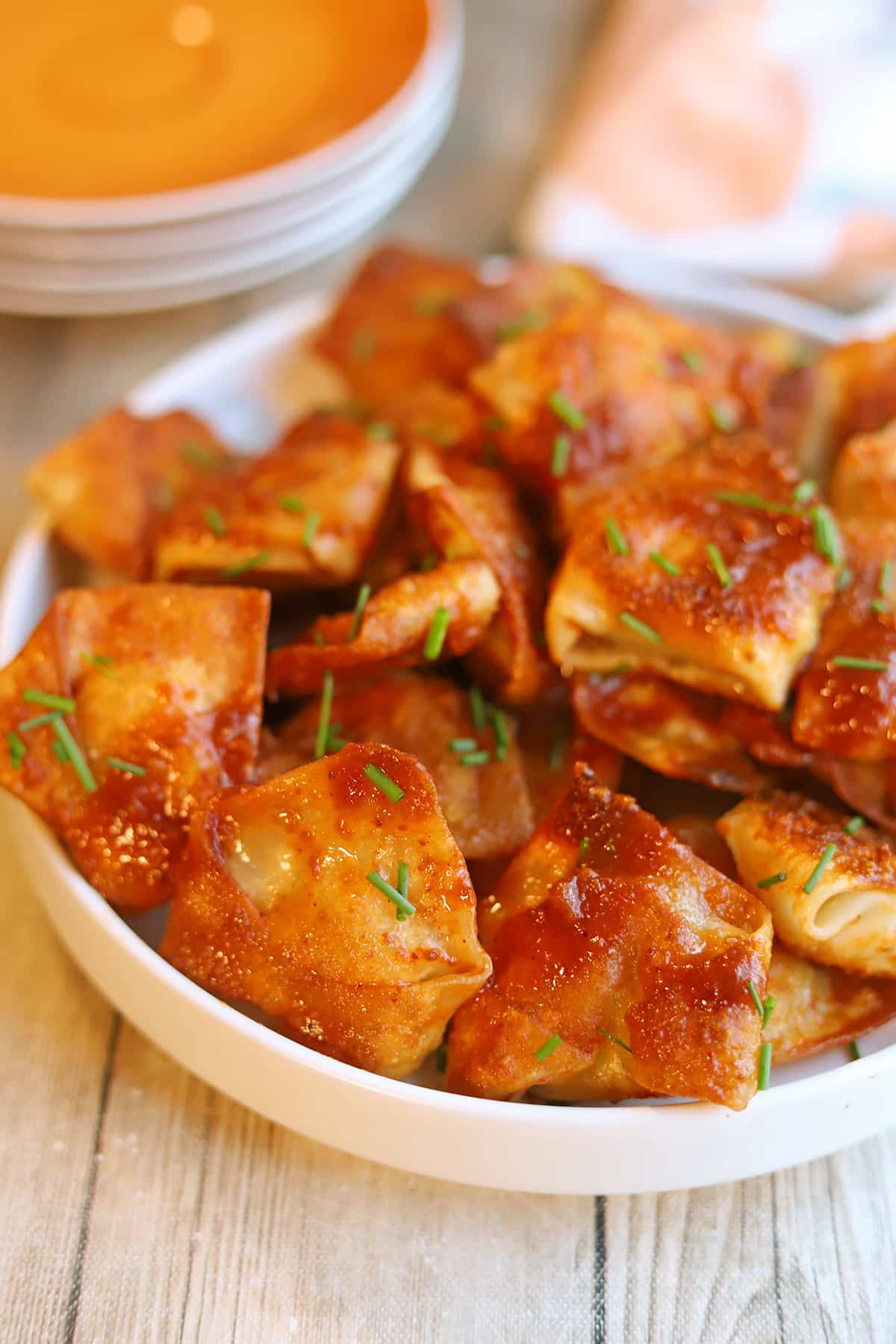 Vegan tofu dumplings with adobo sauce on platter.