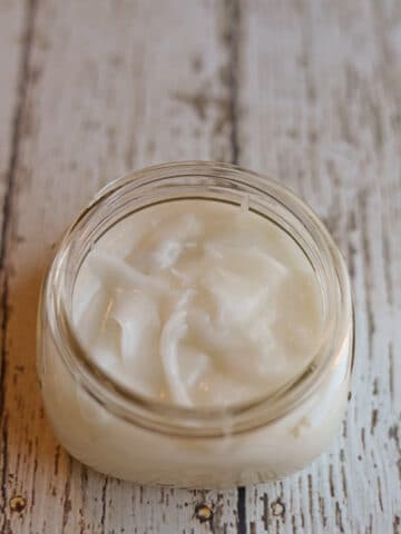 Creamy coconut oil deodorant in glass jar.