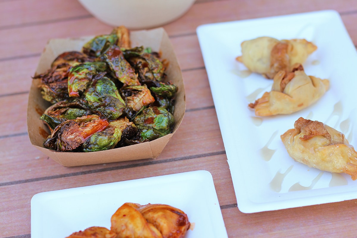 Korean Brussels sprouts at Dumpling Darling in paper basket by dessert dumplings.