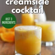 Text overlay: orange creamsicle cocktail, just 3 ingredients, get the recipe at cadryskitchen.com. Gin cocktail with orange juice and sweetened vanilla almond milk in glass.
