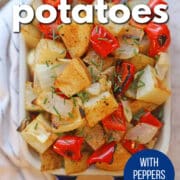 Text overlay: Roasted potatoes with peppers & onions, get the recipe at cadryskitchen.com. Serving dish with roasted potatoes.