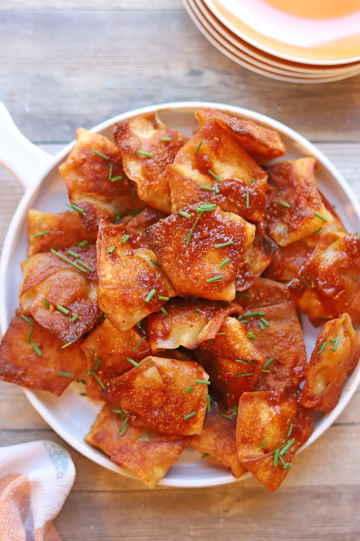 Spicy tofu dumplings tossed in chipotle adobo sauce on platter.