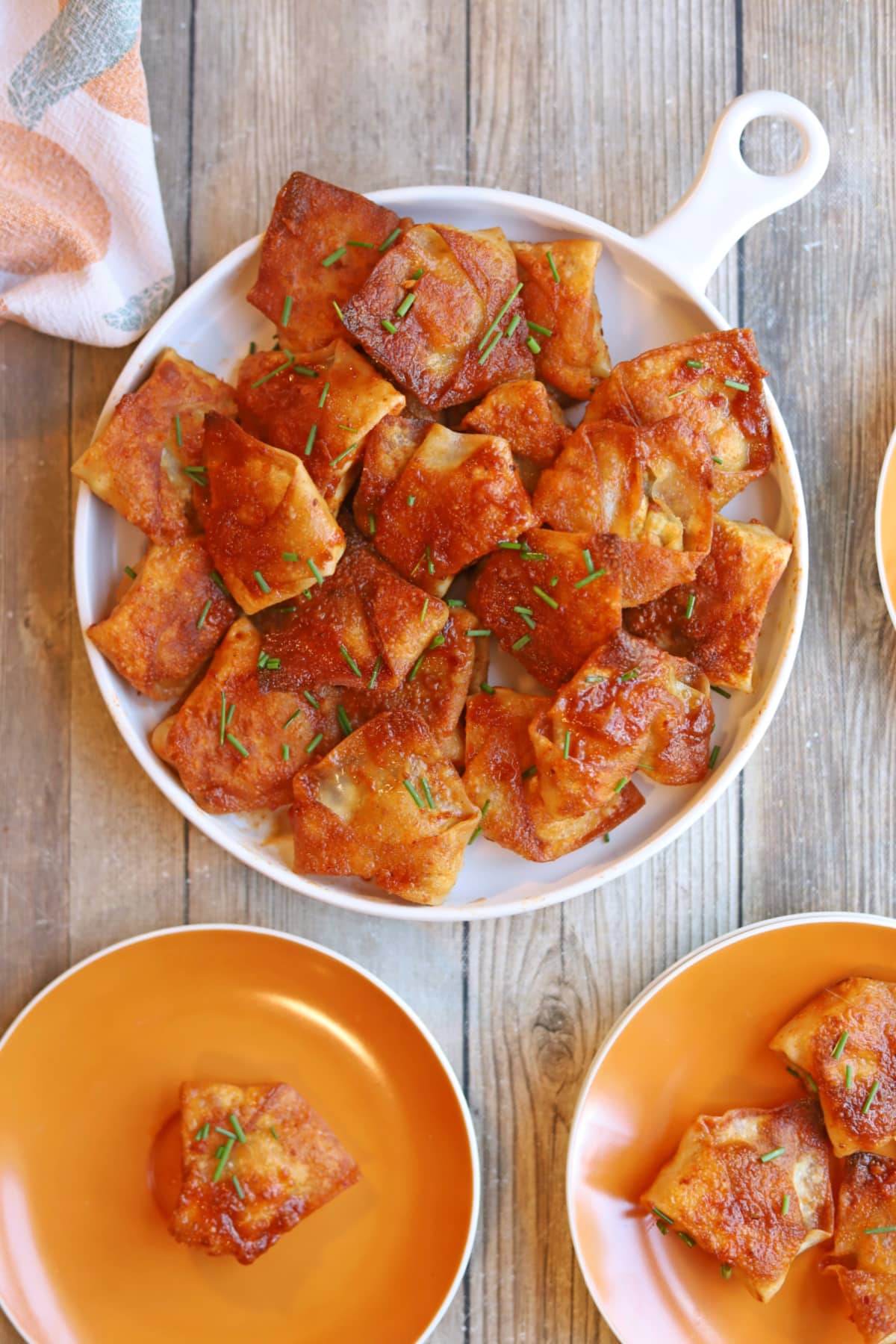 Fried vegan dumplings on platter by serving plates.