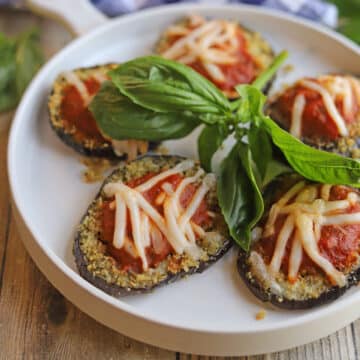 Non-dairy cheese and marinara on vegan eggplant parmesan.