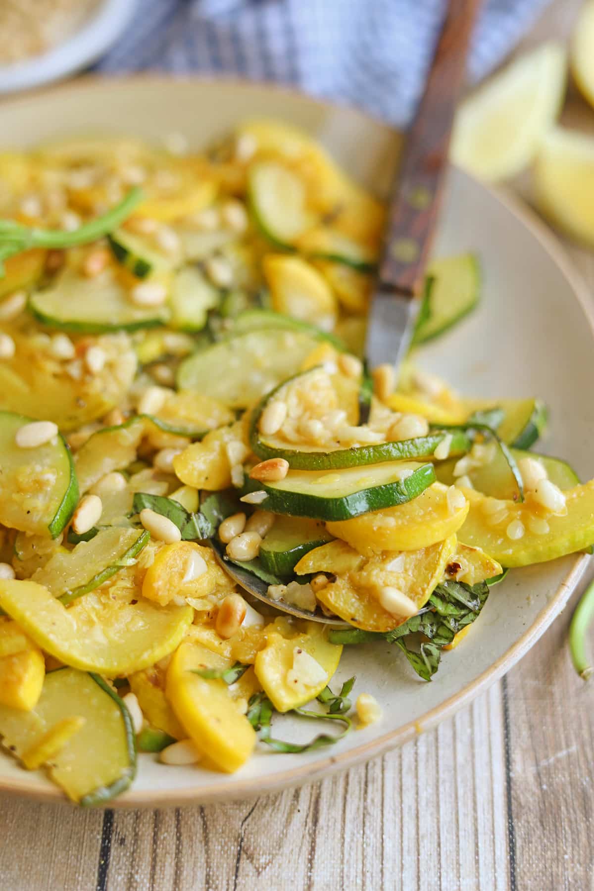 Sauteed zucchini and summer squash on plate with spoon.