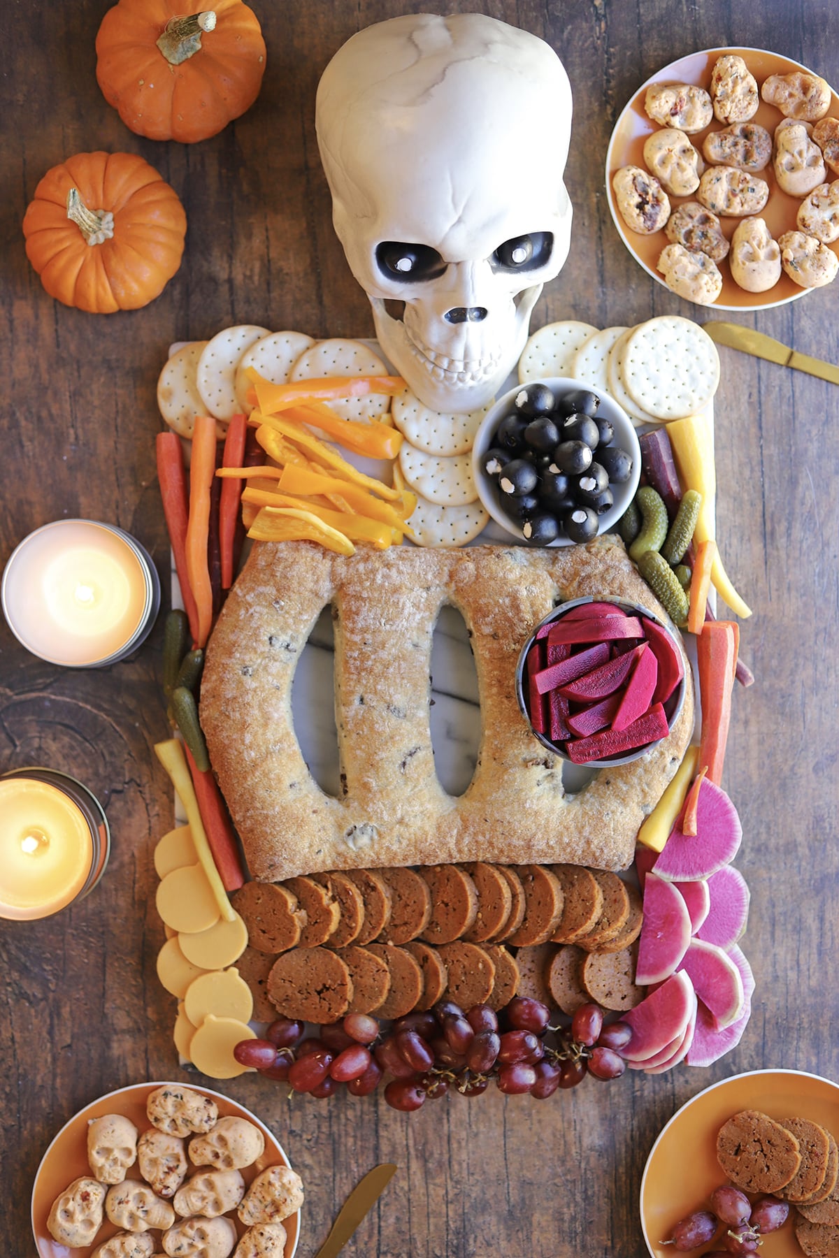 Vegan Halloween charcuterie board skeleton with pepperoni intestines, fougasse ribs, and turnip heart.