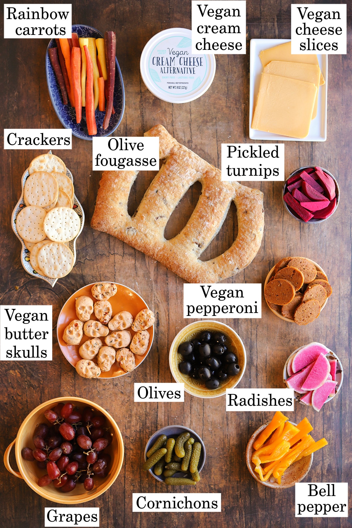 Labeled ingredients for a vegan Halloween charcuterie board skeleton.