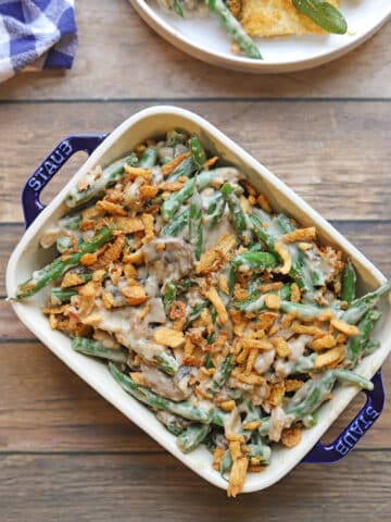 Green bean casserole with a cashew cream mushroom sauce, topped with fried onions.