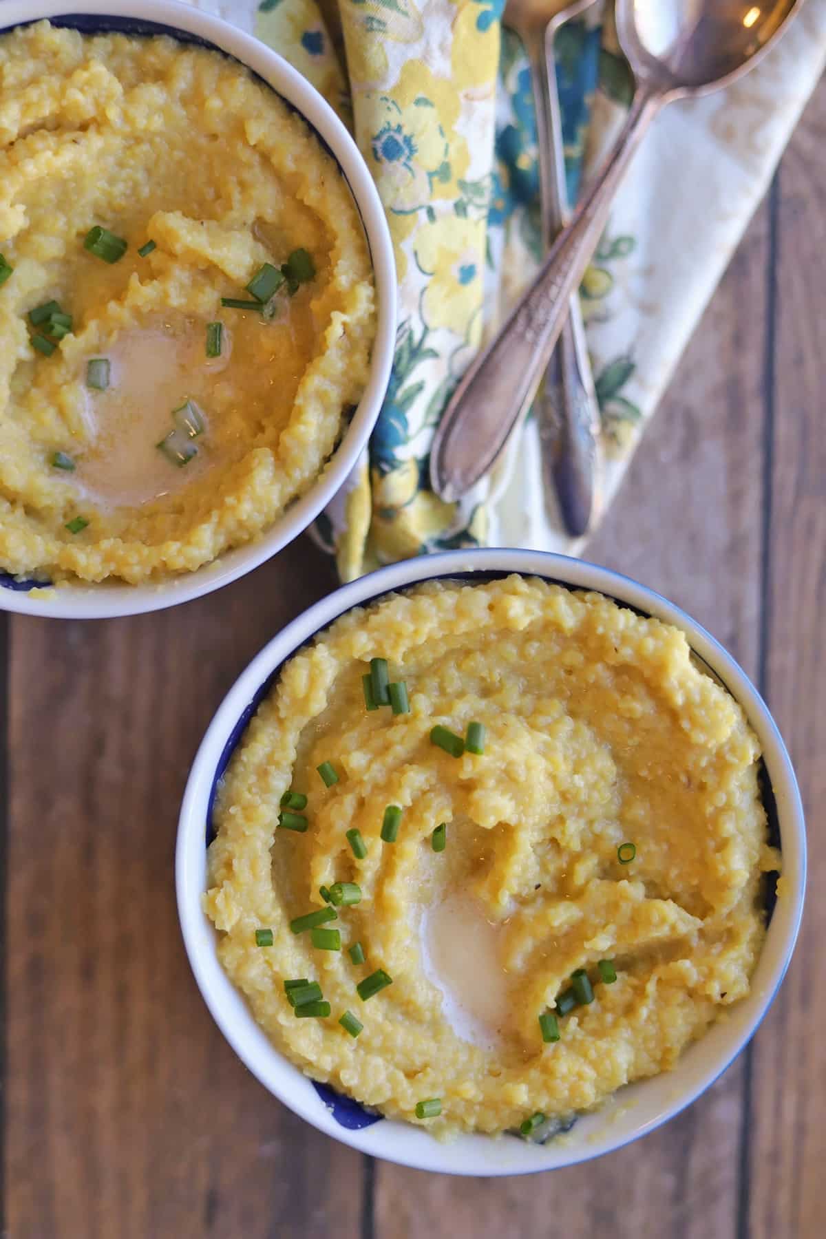 Vegan grits warm breakfast in bowls with spoons and napkin.