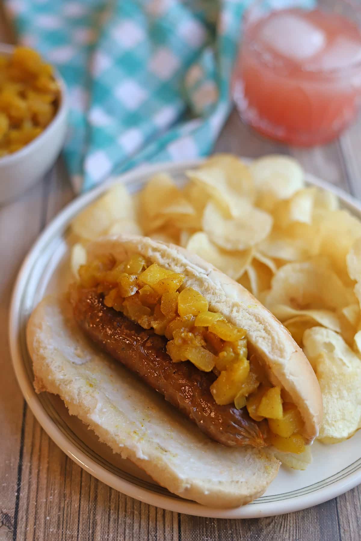 Apple chutney piled on Impossible sausage with potato chips and grapefruit juice.