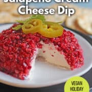 Text overlay: Cranberry jalapeno cream cheese dip, vegan holiday appetizer, get the recipe at cadryskitchen.com. Cranberry jalapeno cream cheese dip on plate with garnish.