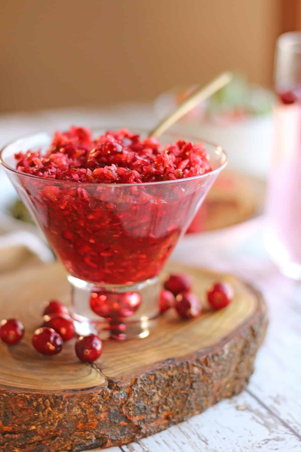 Cranberry salsa in bowl surrounded with cranberries.