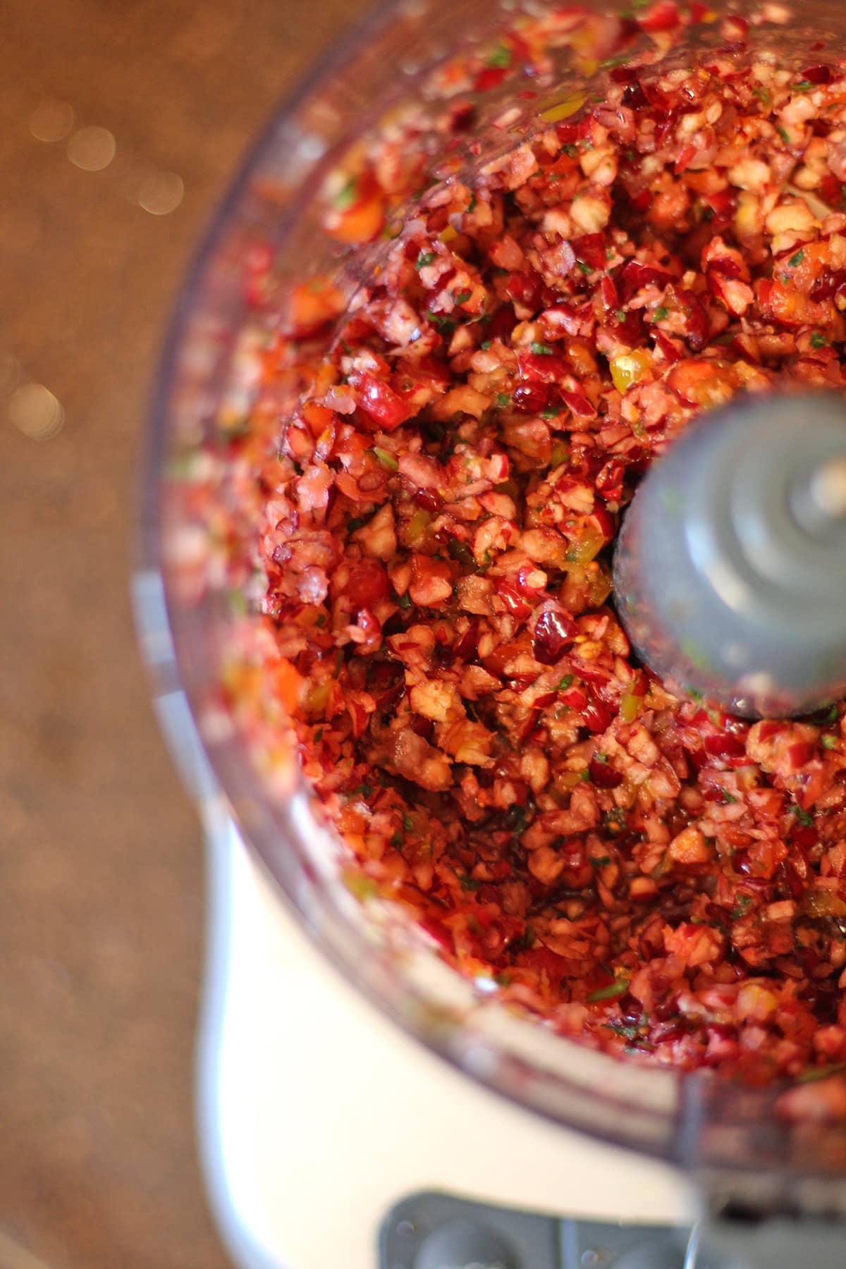 Cranberry salsa with jalapeno in food processor.