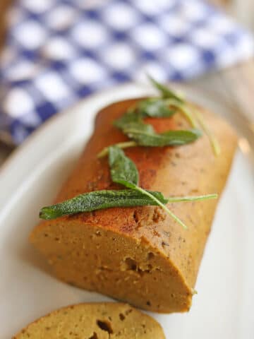 Fried sage leaves garnish on top of seitan turkey.