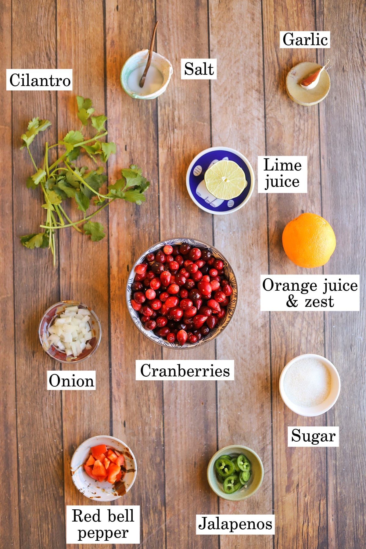 Labeled ingredients for cranberry salsa on table.