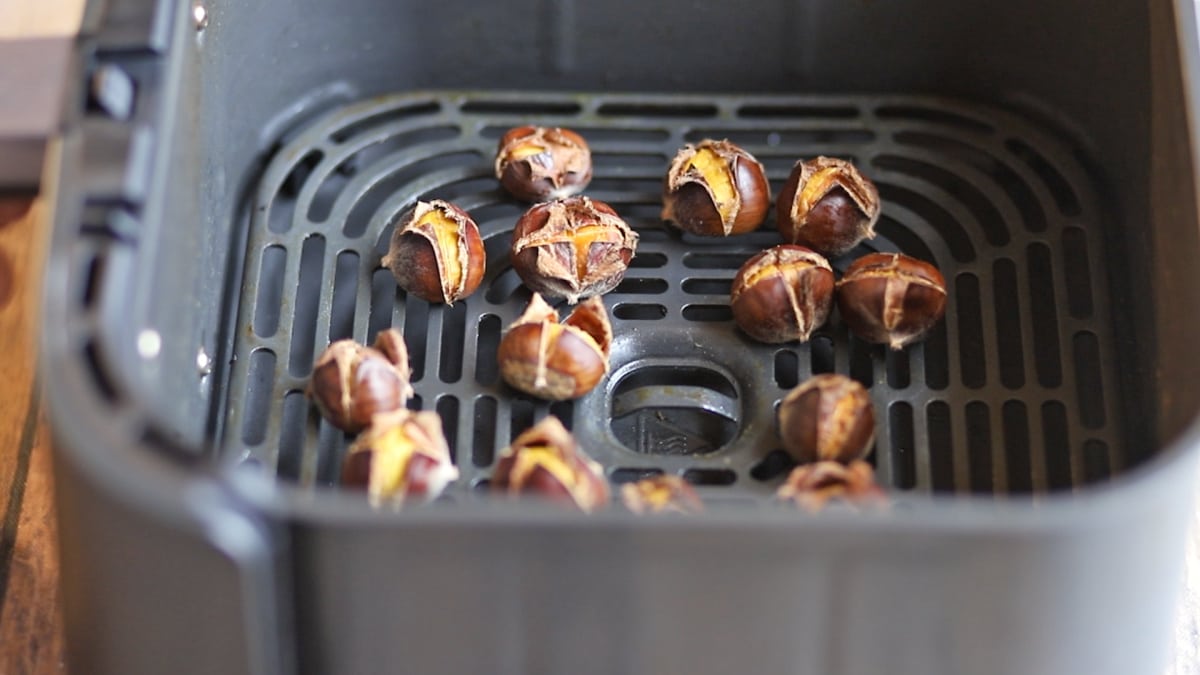 Chestnuts in shell in air fryer basket.