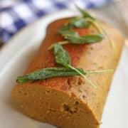 Crispy fried sage leaves garnishing vegan turkey roast.