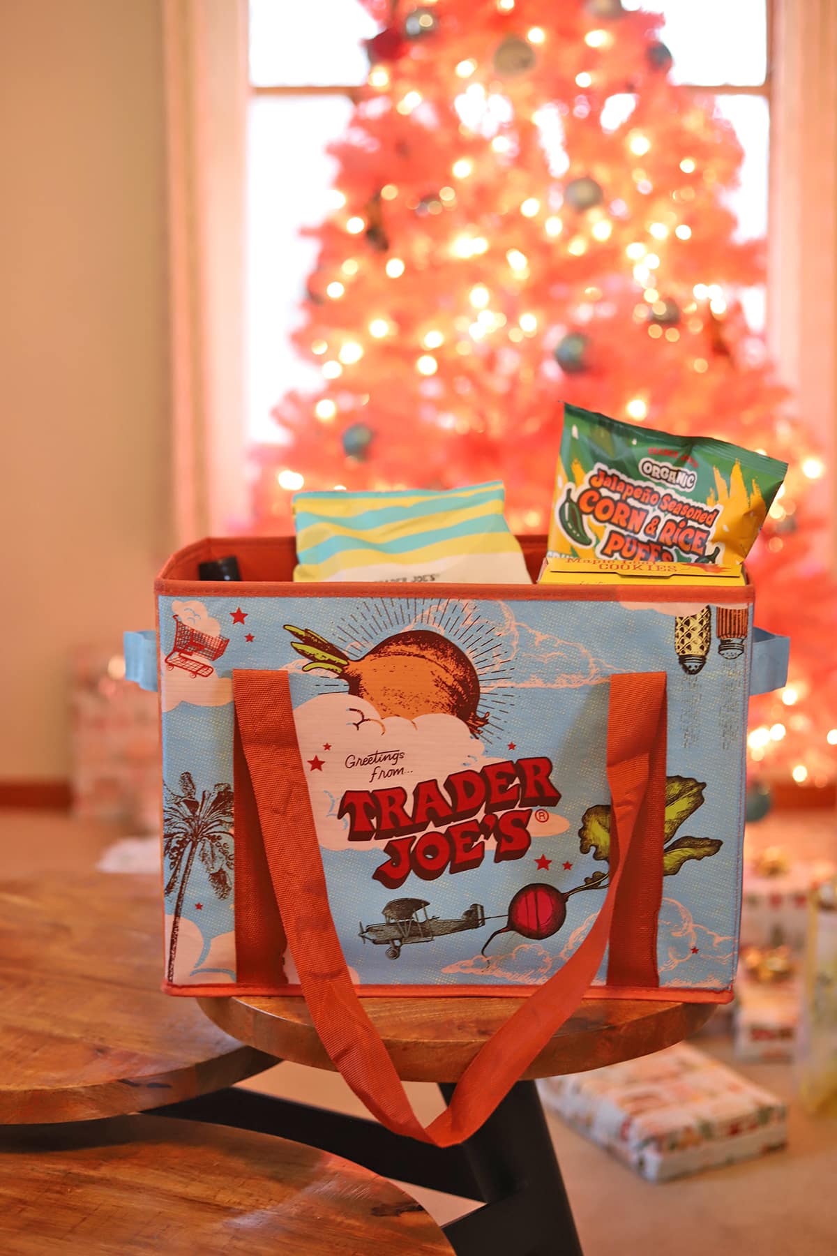 Trader Joe's present in front of Christmas tree.