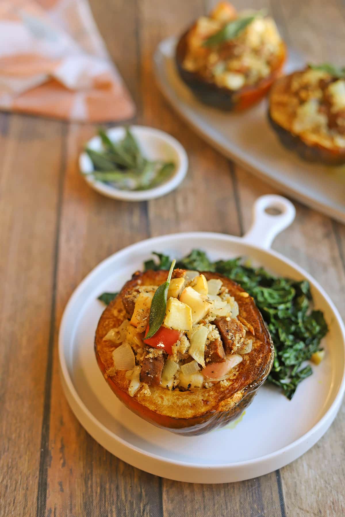 Vegan stuffed acorn squash Thanksgiving main course on plate with kale.