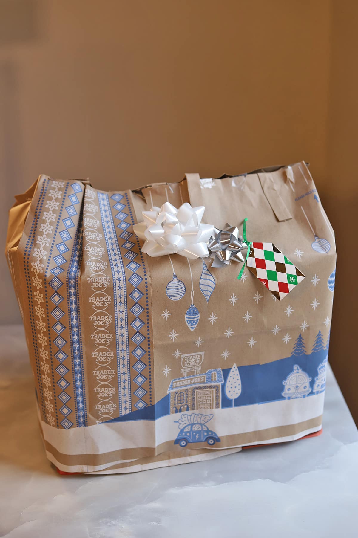 Trader Joe's gift bag wrapped in Trader Joe's bag with bows.