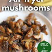 Text overlay: Air fryer mushrooms, garlic and herbs, cadryskitchen.com. Perfectly browned mushrooms dotted with rosemary and thyme.