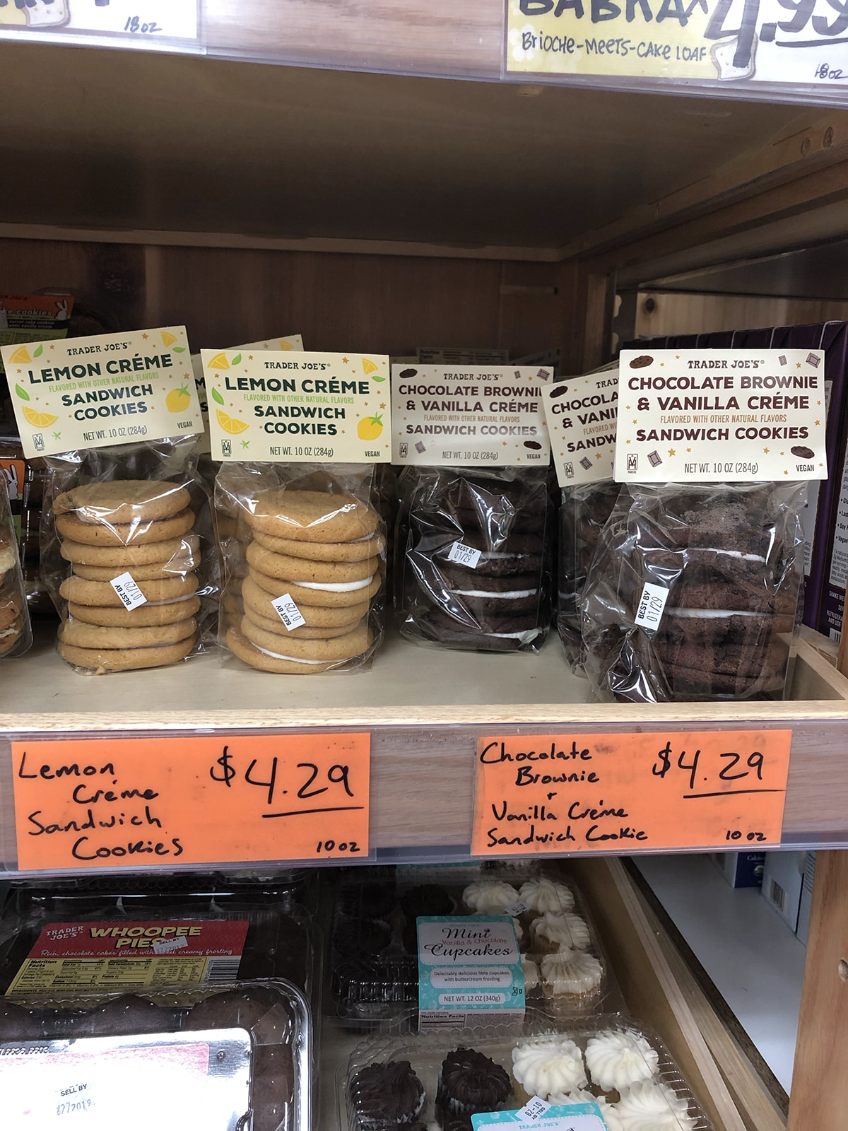 Two flavors of sandwich cookies on store shelf - lemon creme sandwich cookies, and chocolate brownie & vanilla sandwich cookies.