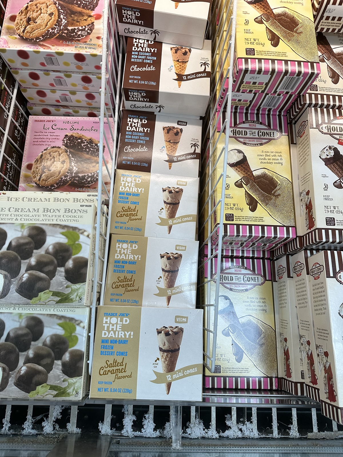 Trader Joe's hold the dairy salted caramel dessert cones in freezer case.