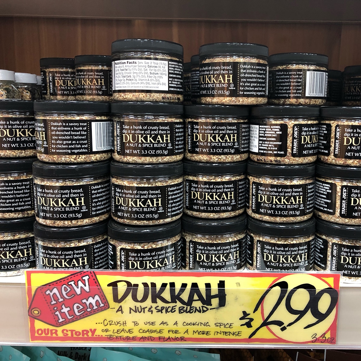 Containers of dukkah nut and spice blend on display at Trader Joe's.