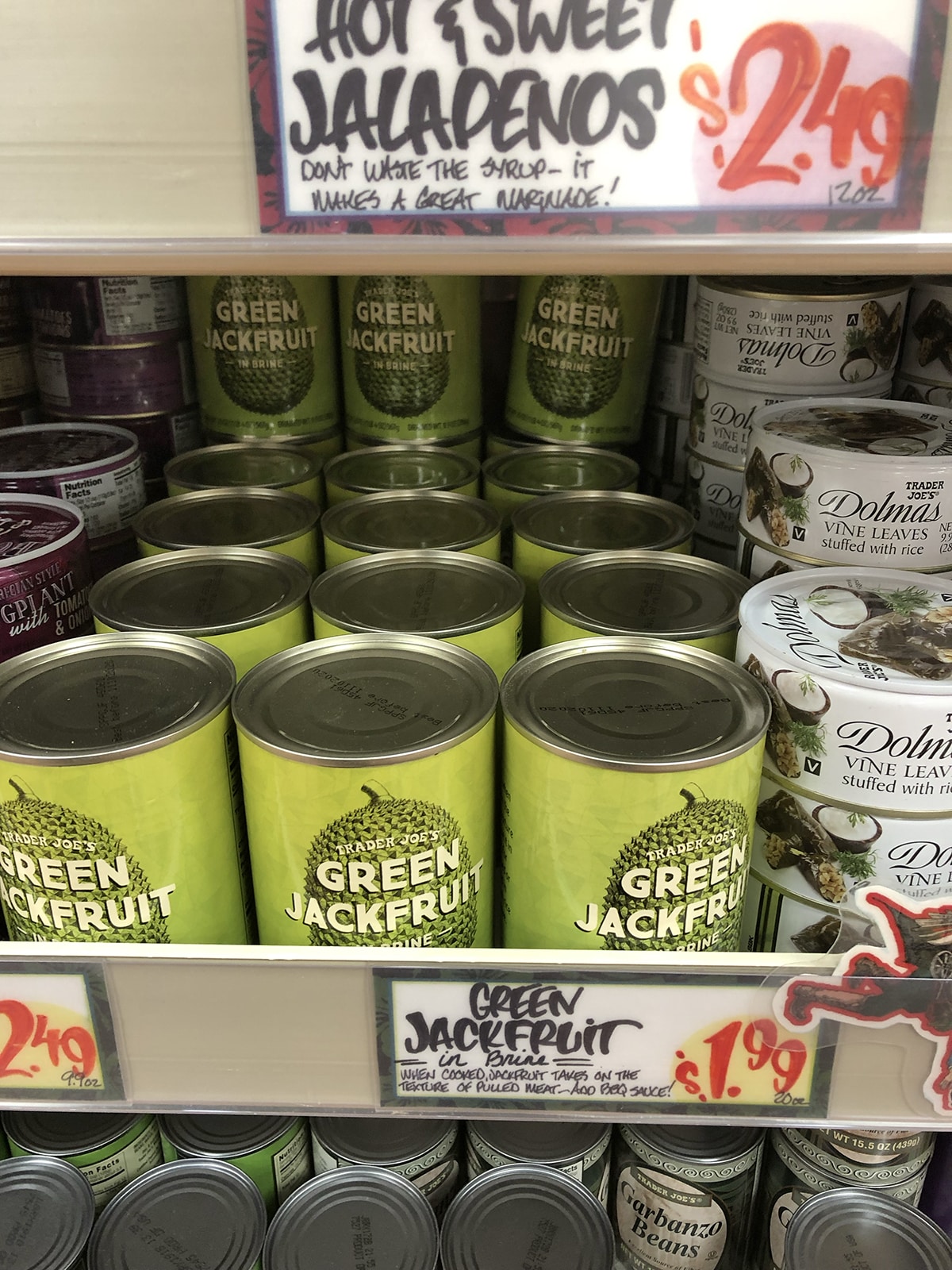 Canned green jackfruit in brine on store shelf.