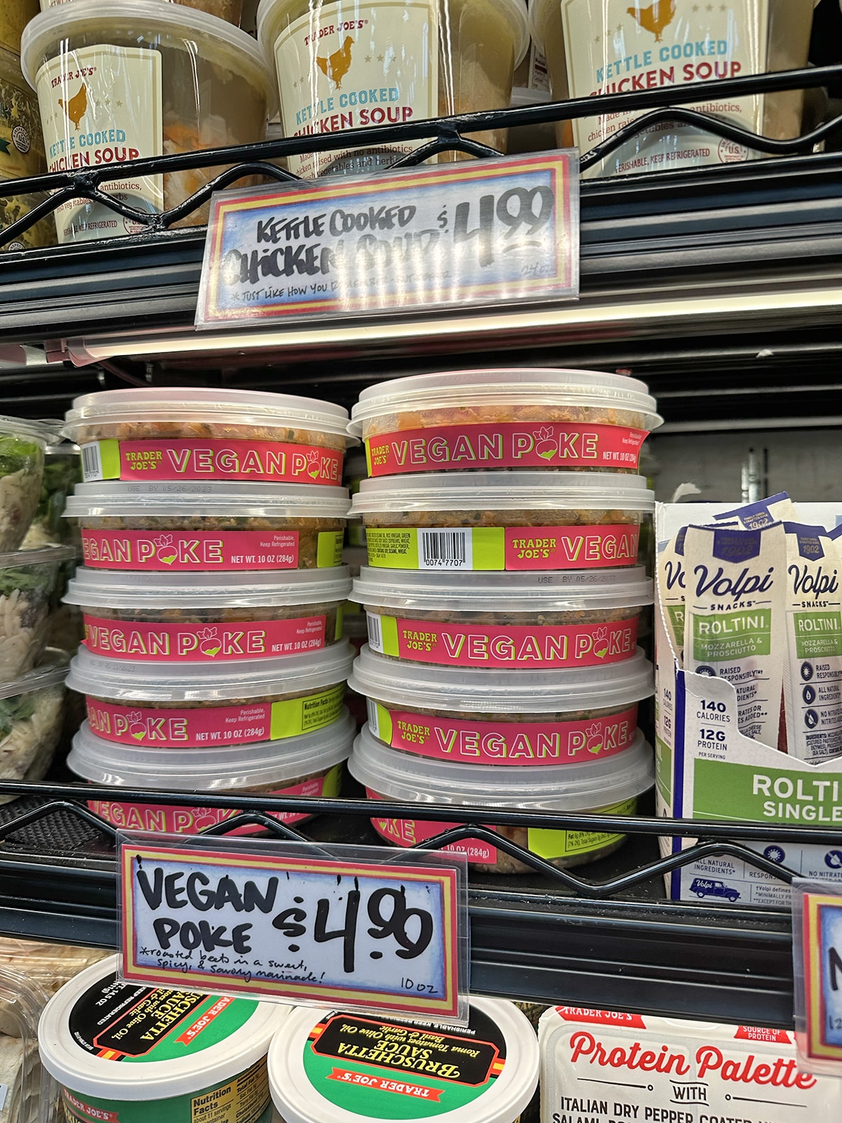 Vegan poke stacked in refrigerated case at Trader Joe's.